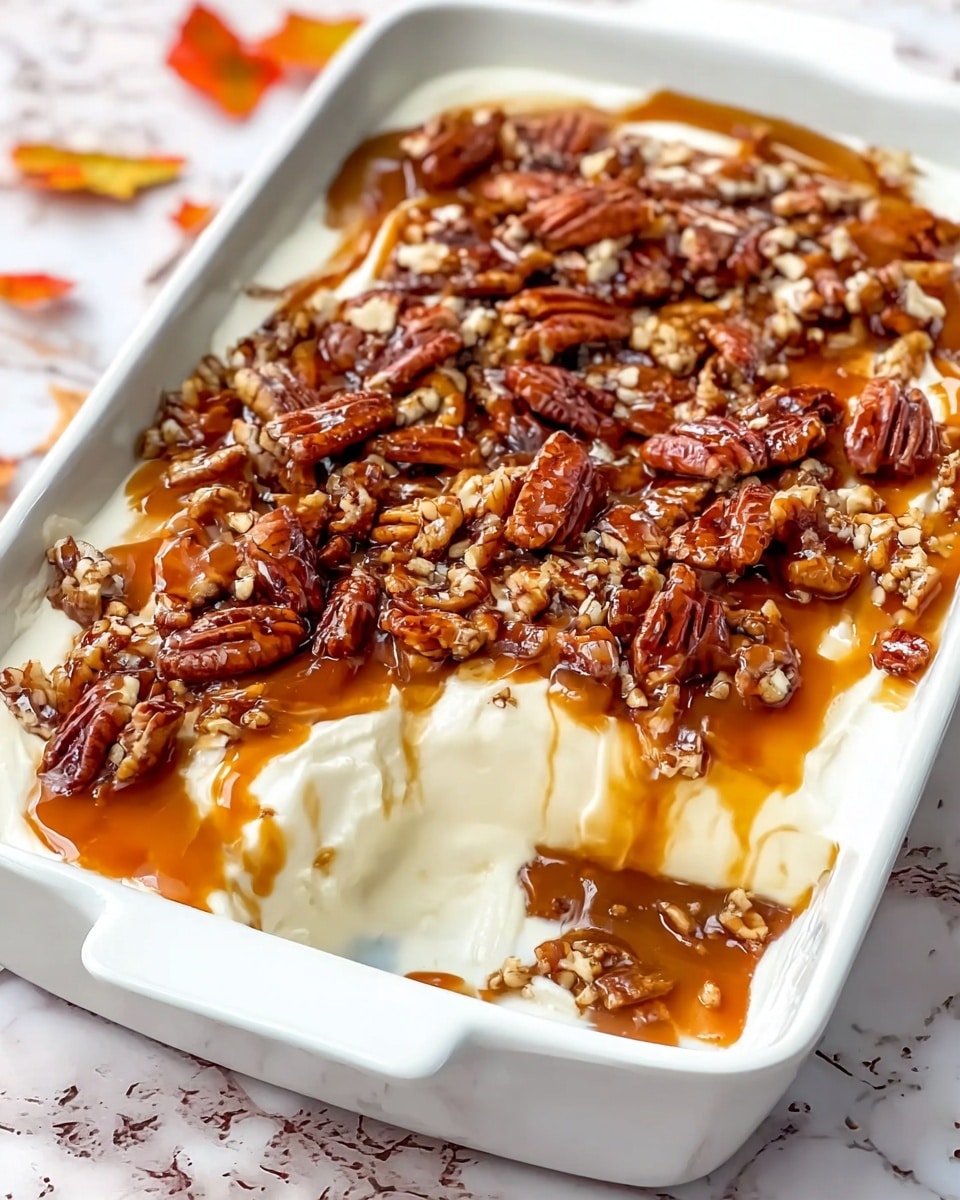 A white square dish filled with a layered dip starting with a creamy white base layer topped with a thick, glossy brown layer, scattered with large pecan nuts. A woman's hand holds a round cracker dipped into the dish, showing the creamy white layer and brown layer with pecans on top. The dish sits on a woven mat decorated with bright orange and red autumn leaves, all set against a white marbled textured surface. In the background, there are blurred white bowls filled with yellow round crackers. Photo taken with an iphone --ar 4:5 --v 7