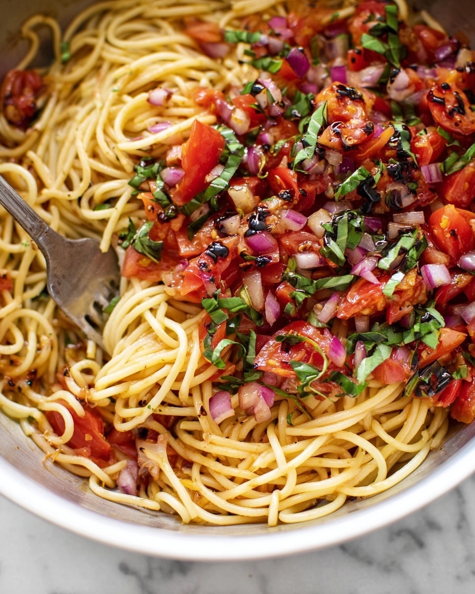A close-up of a white bowl filled with cooked orzo pasta mixed with browned ground meat, small red tomato pieces, and green herbs scattered on top. The pasta is shiny and coated in a light tomato sauce. The bowl is placed on a white marbled surface, and the background has a blurred bottle with yellow liquid and some green plants. photo taken with an iphone --ar 4:5 --v 7